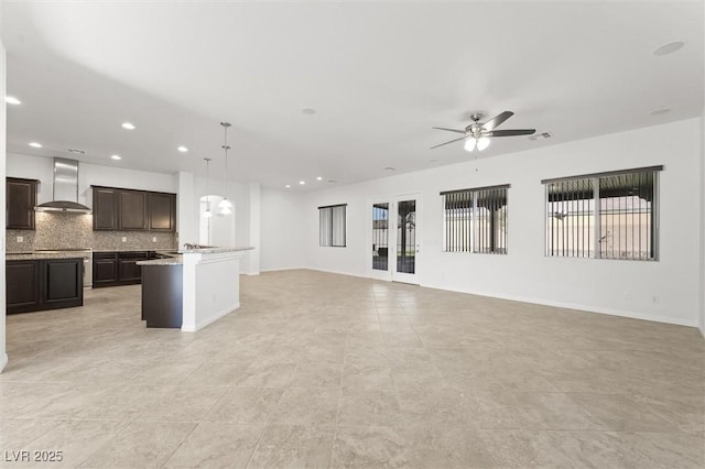 unfurnished living room featuring ceiling fan and light tile patterned floors