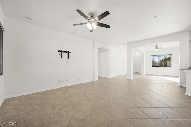 unfurnished living room with ceiling fan and light tile patterned floors