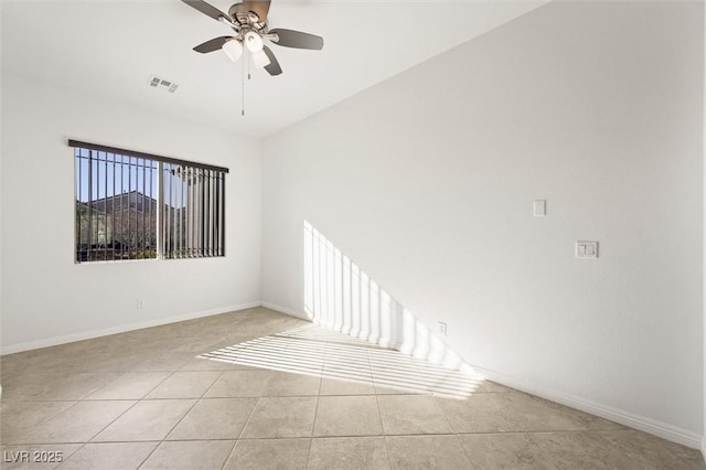 tiled spare room featuring ceiling fan