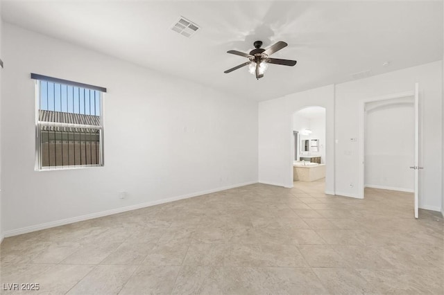 unfurnished bedroom with ensuite bath, ceiling fan, and light tile patterned floors