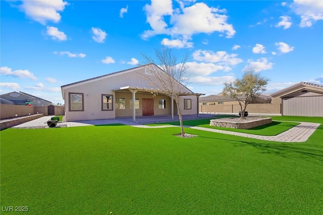 rear view of property with a lawn and a patio