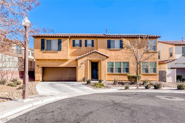 view of front of property featuring stucco siding, driveway, a tile roof, and an attached garage