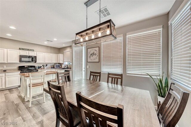 dining space with light hardwood / wood-style flooring