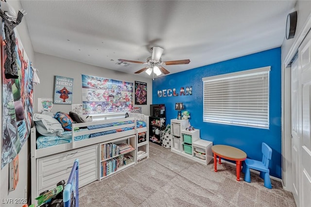 interior space featuring ceiling fan and light colored carpet