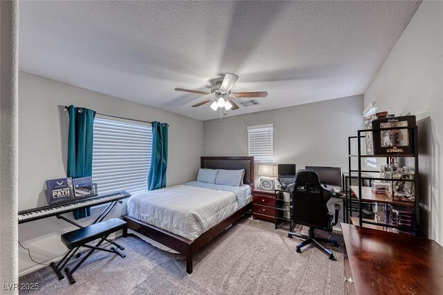 bedroom featuring a textured ceiling, ceiling fan, and carpet floors