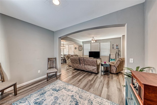 living room featuring ceiling fan and hardwood / wood-style floors