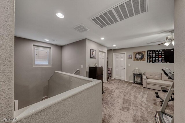 office with ceiling fan and light carpet