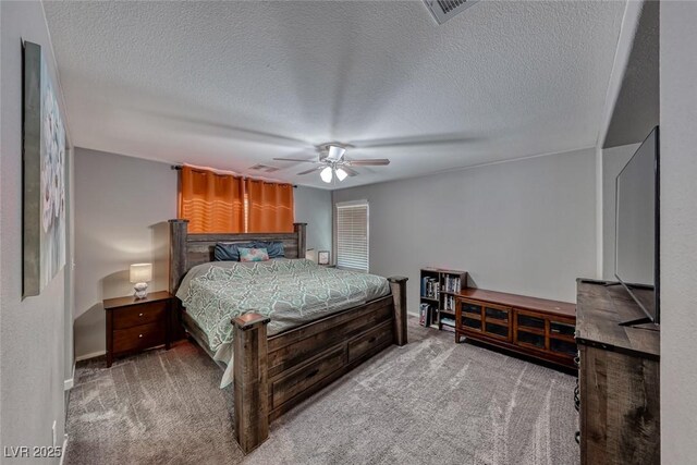 carpeted bedroom with a textured ceiling and ceiling fan