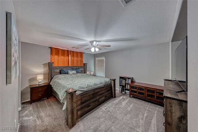 bedroom featuring light colored carpet, a textured ceiling, and ceiling fan