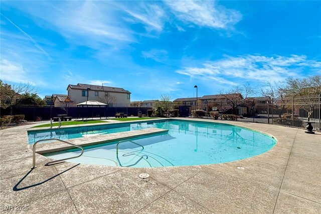 view of pool with a diving board