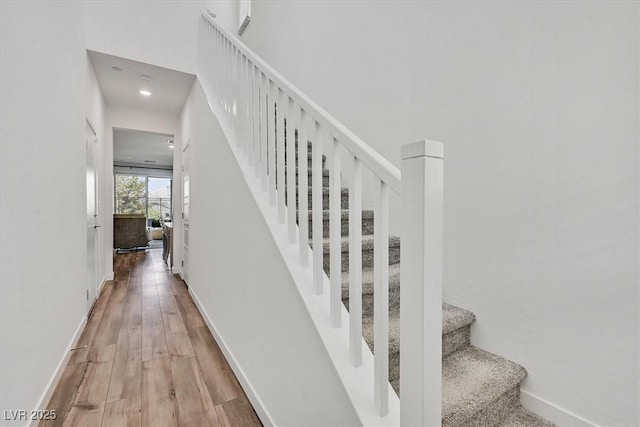 stairs with hardwood / wood-style floors