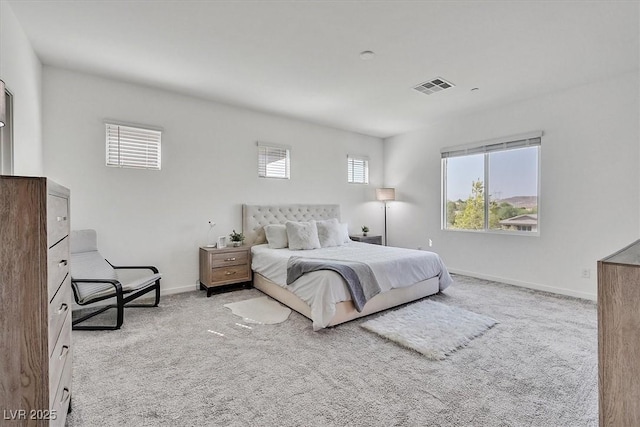 carpeted bedroom with multiple windows