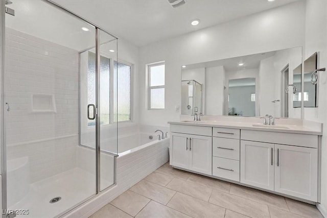 bathroom featuring vanity, tile patterned floors, and separate shower and tub