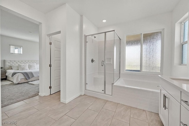 bathroom featuring independent shower and bath, tile patterned floors, and vanity