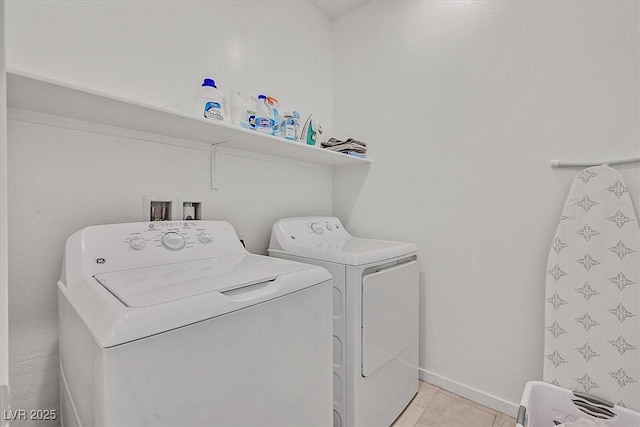 washroom with washer and dryer and light tile patterned flooring