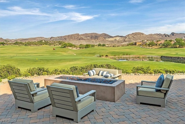 view of patio / terrace featuring an outdoor fire pit and a water and mountain view