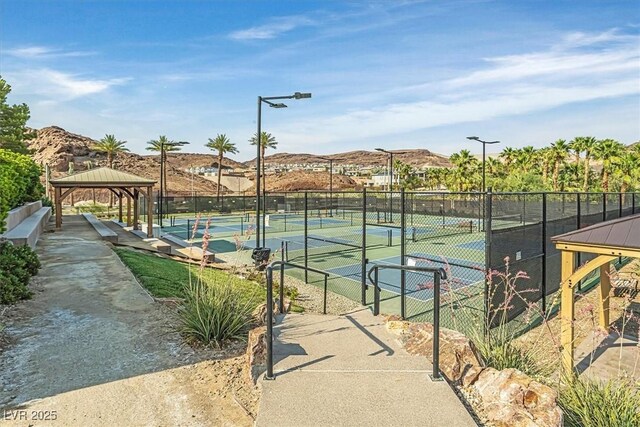 view of tennis court featuring a gazebo and a mountain view