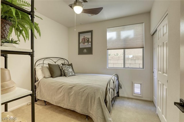 carpeted bedroom featuring multiple windows, a closet, and ceiling fan