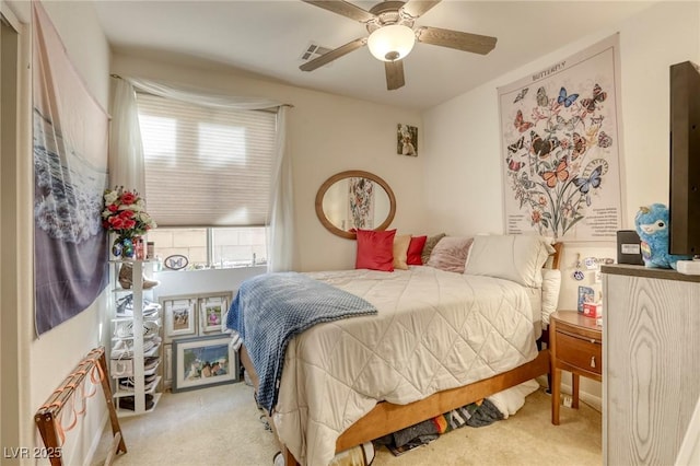 bedroom featuring ceiling fan and light colored carpet