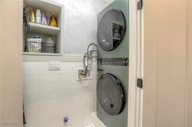 laundry room with stacked washing maching and dryer