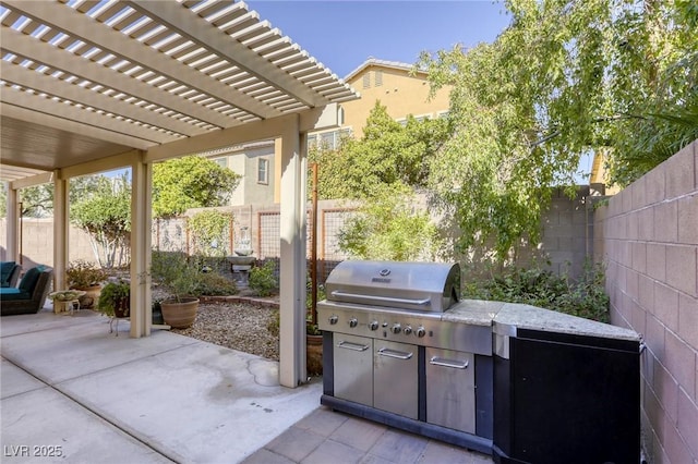 view of patio featuring an outdoor kitchen and a pergola