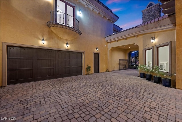 exterior space featuring decorative driveway