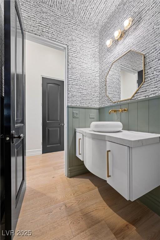 bathroom with vanity and wood finished floors