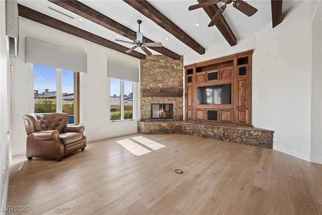 living area featuring hardwood / wood-style floors, a fireplace, and baseboards