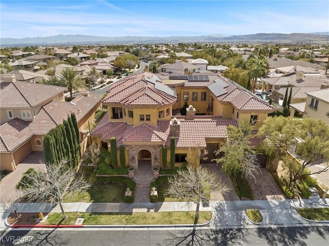 drone / aerial view featuring a residential view and a mountain view