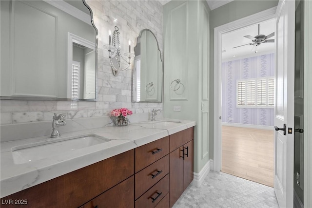 full bathroom with ceiling fan, double vanity, a sink, and wallpapered walls