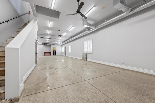 garage featuring a ceiling fan and baseboards