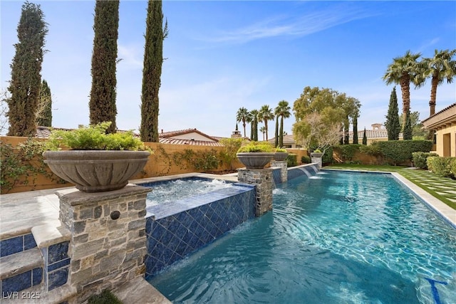 view of pool featuring a fenced backyard, a fenced in pool, and an in ground hot tub