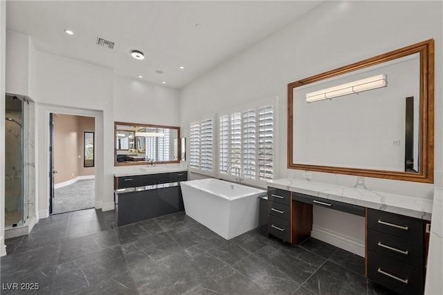 full bathroom with recessed lighting, visible vents, a shower stall, vanity, and a freestanding tub