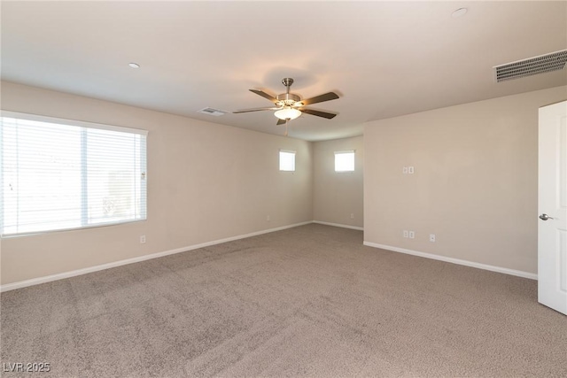 carpeted empty room featuring ceiling fan