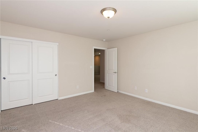 unfurnished bedroom with a closet and light carpet