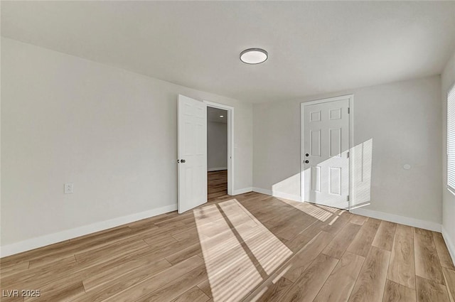 unfurnished room with light wood-type flooring