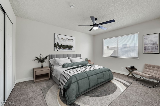 bedroom featuring carpet flooring, a closet, ceiling fan, and a textured ceiling