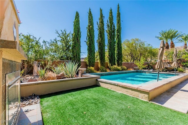 view of swimming pool featuring a yard