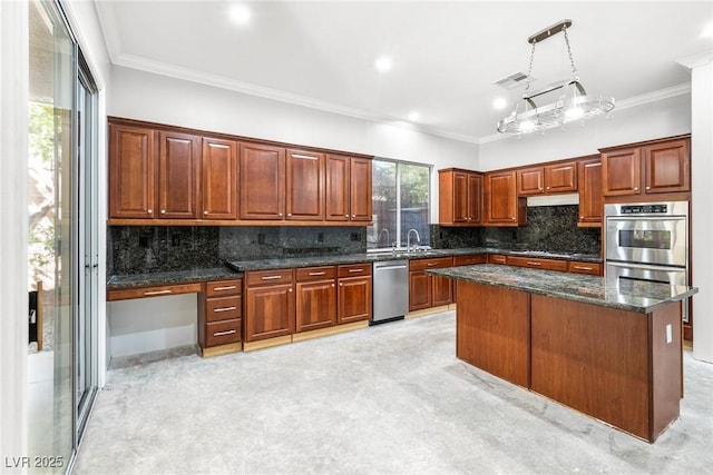 kitchen featuring stainless steel appliances, dark stone countertops, a kitchen island, pendant lighting, and crown molding