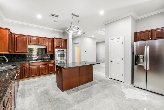 kitchen featuring stainless steel appliances, pendant lighting, decorative backsplash, a kitchen island, and sink