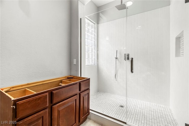 bathroom featuring a shower with door