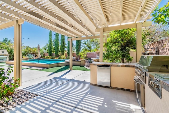 view of patio featuring exterior kitchen and a pergola