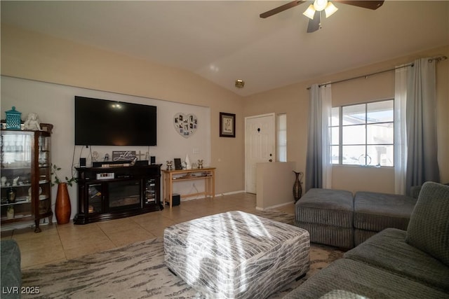 living room with vaulted ceiling, ceiling fan, and light tile patterned floors