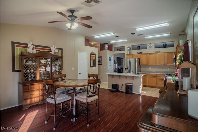 dining area with lofted ceiling, dark wood-type flooring, and ceiling fan