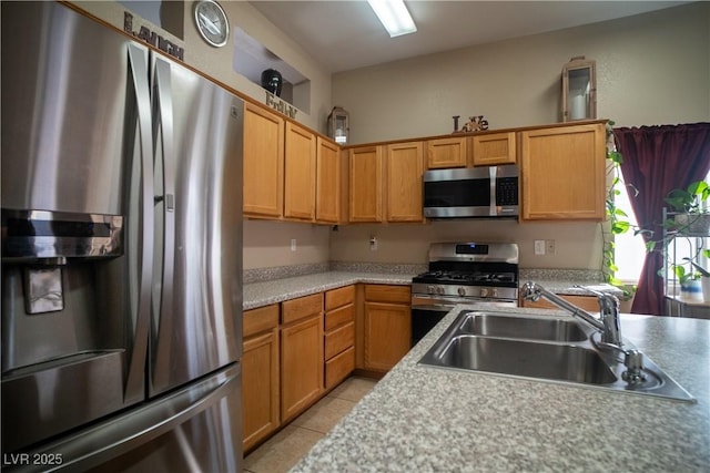 kitchen featuring appliances with stainless steel finishes, light tile patterned flooring, and sink