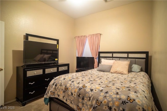 bedroom featuring vaulted ceiling and light colored carpet