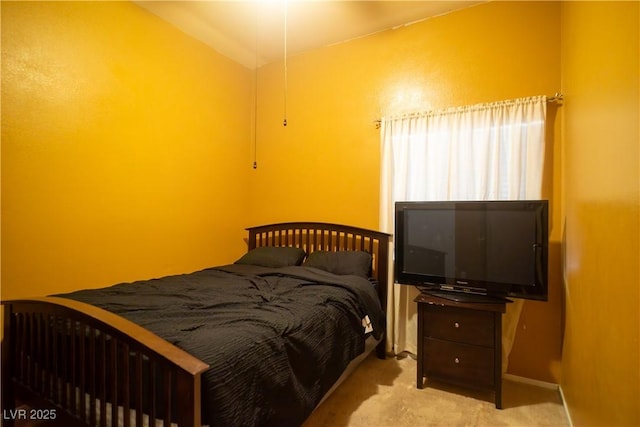 bedroom with vaulted ceiling and light carpet