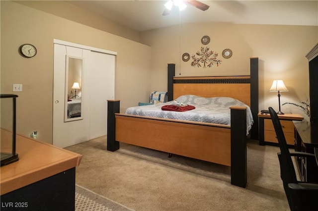 carpeted bedroom with vaulted ceiling, ceiling fan, and a closet