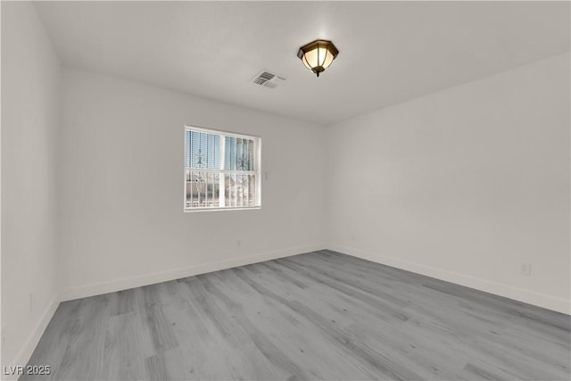 spare room featuring light wood-type flooring