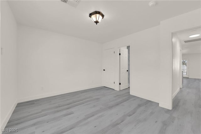 spare room with light hardwood / wood-style floors